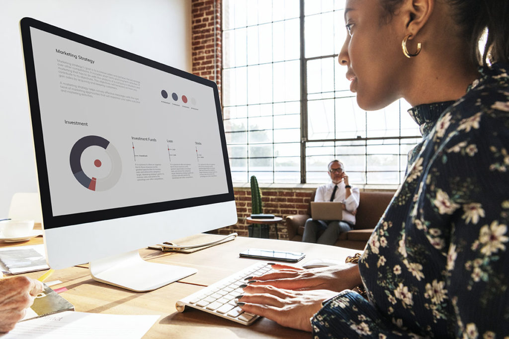 Woman reading Marketing Plan on Computer